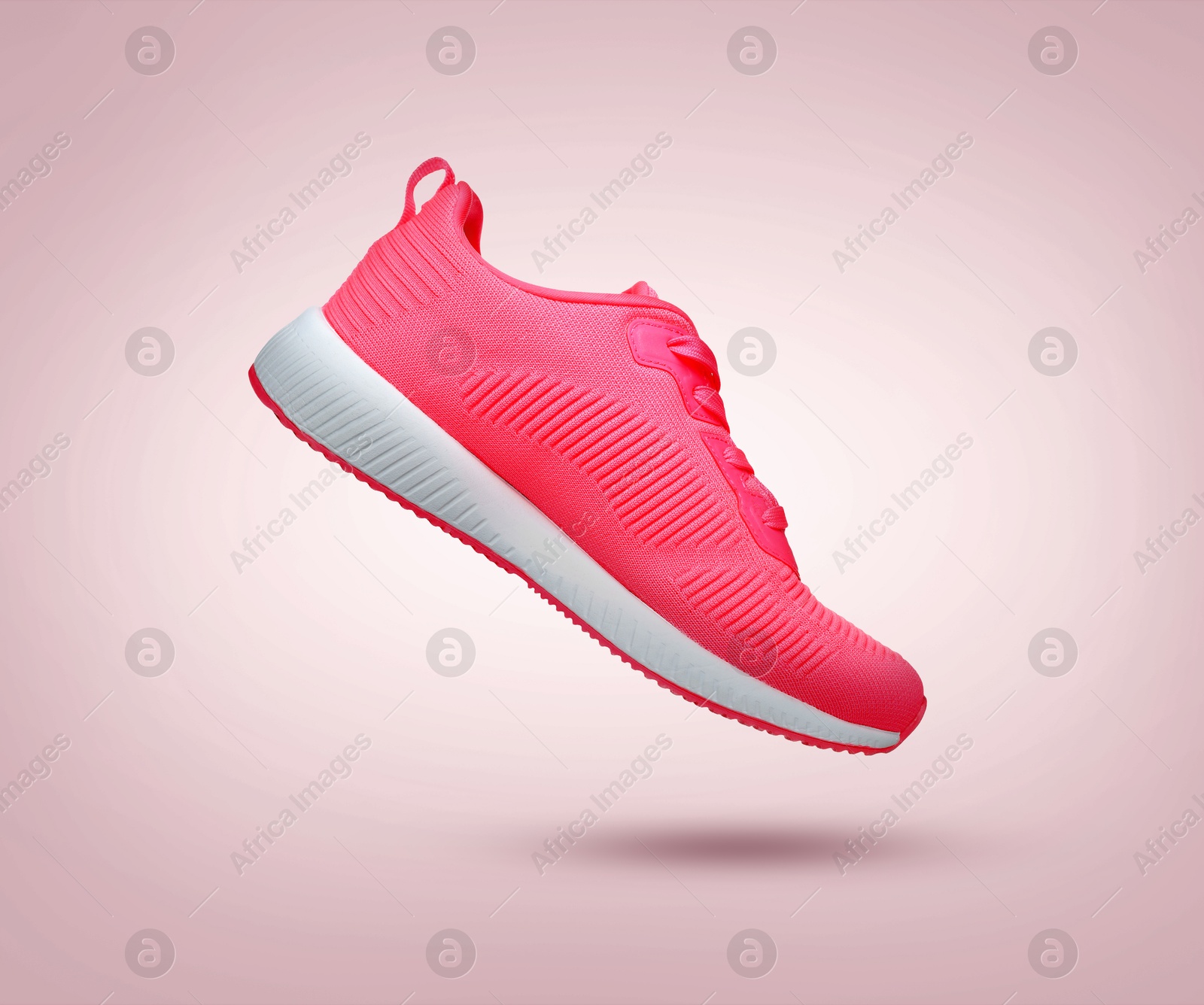 Stylish sneaker in air on dusty pink gradient background Image of Stylish sneaker in air on dusty pink gradient background