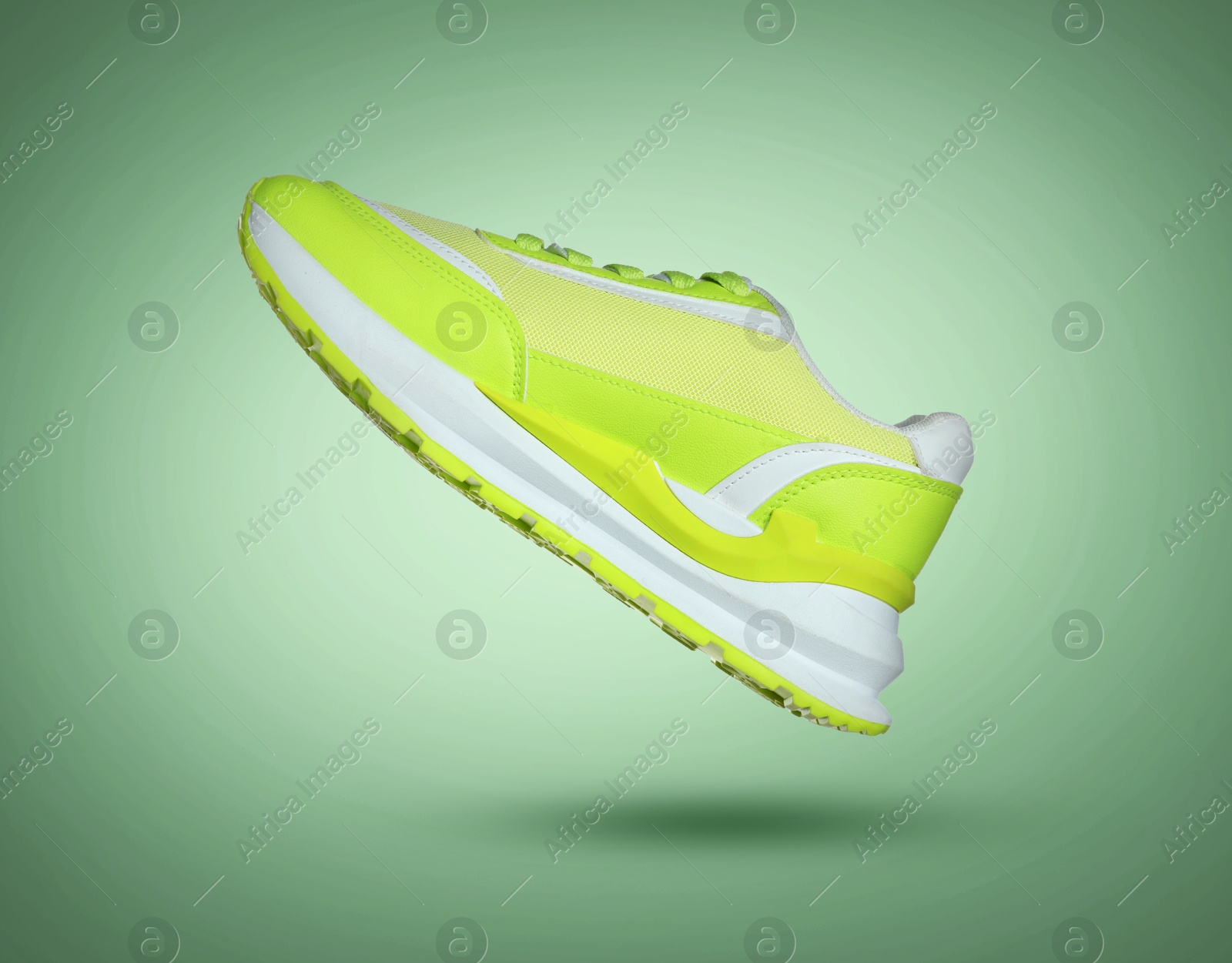 Fashionable sneaker in air on green gradient background Image of Fashionable sneaker in air on green gradient background