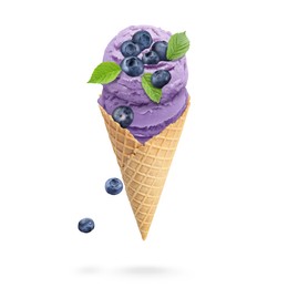 Image of Yummy blueberry ice cream cone and berries in air on white background