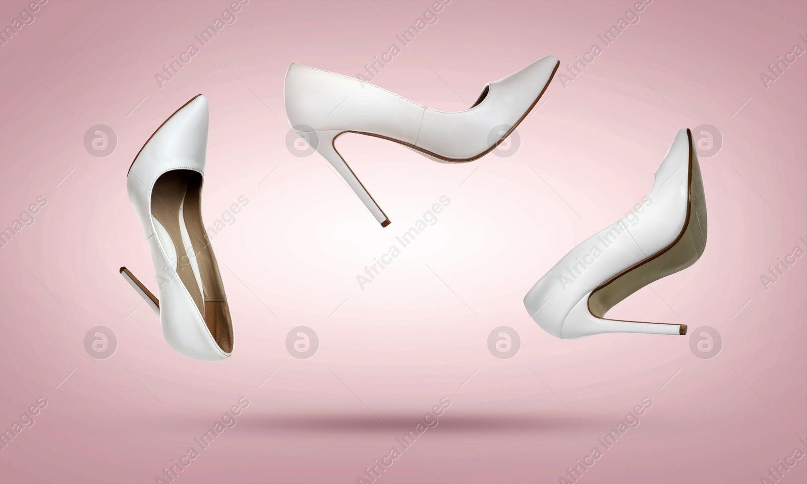 Stylish high heel shoes in air on dusty pink gradient background Image of Stylish high heel shoes in air on dusty pink gradient background