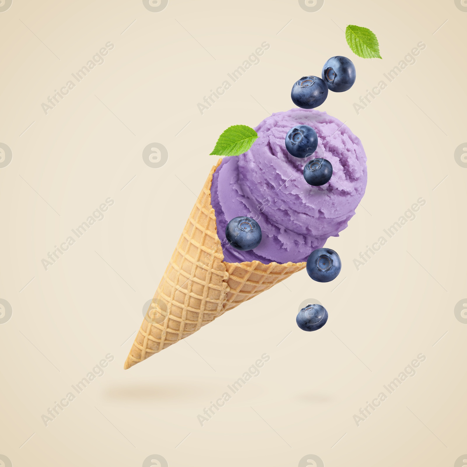 Yummy blueberry ice cream cone and berries in air on greige background Image of Yummy blueberry ice cream cone and berries in air on greige background
