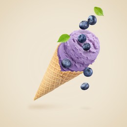 Image of Yummy blueberry ice cream cone and berries in air on greige background