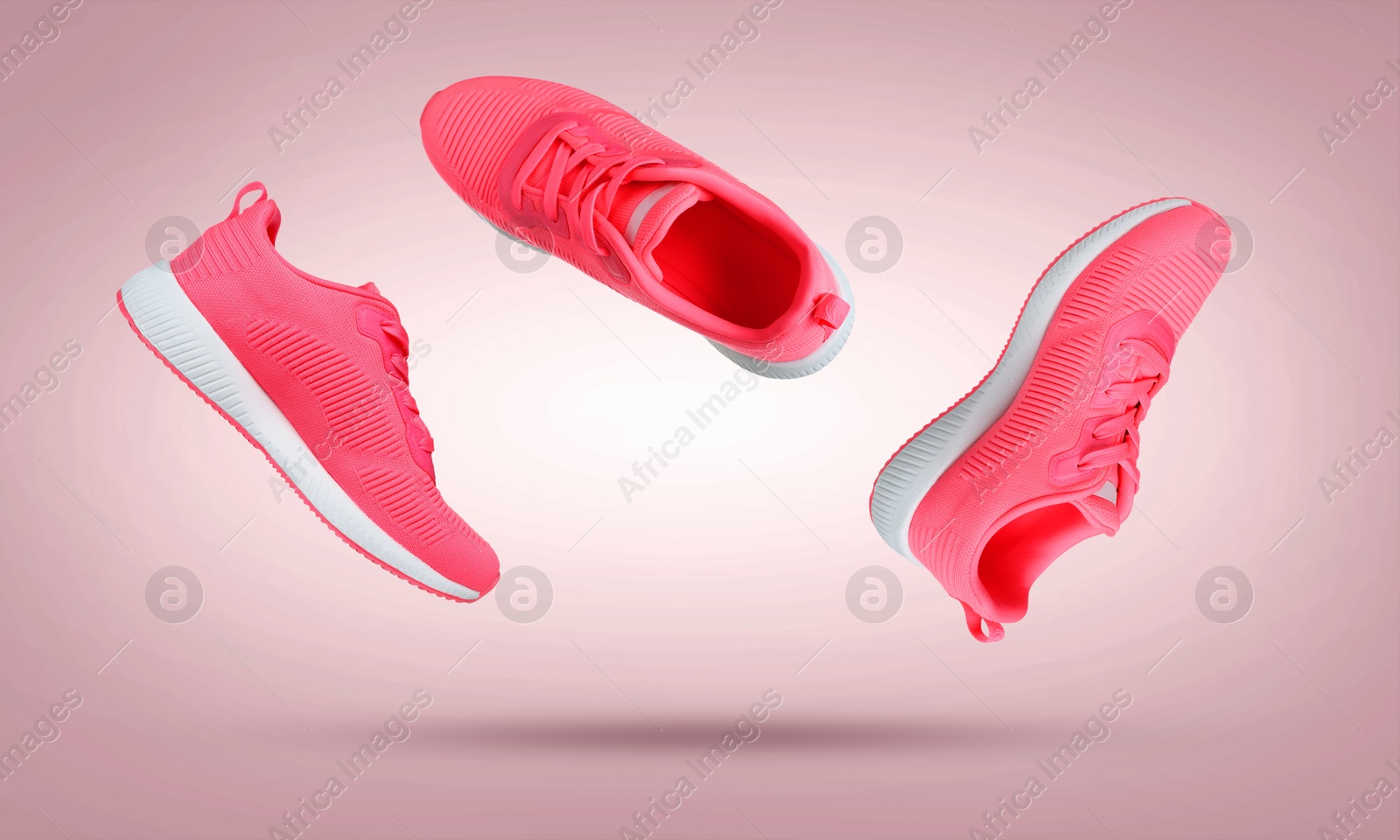 Stylish sneakers in air on dusty pink gradient background Image of Stylish sneakers in air on dusty pink gradient background