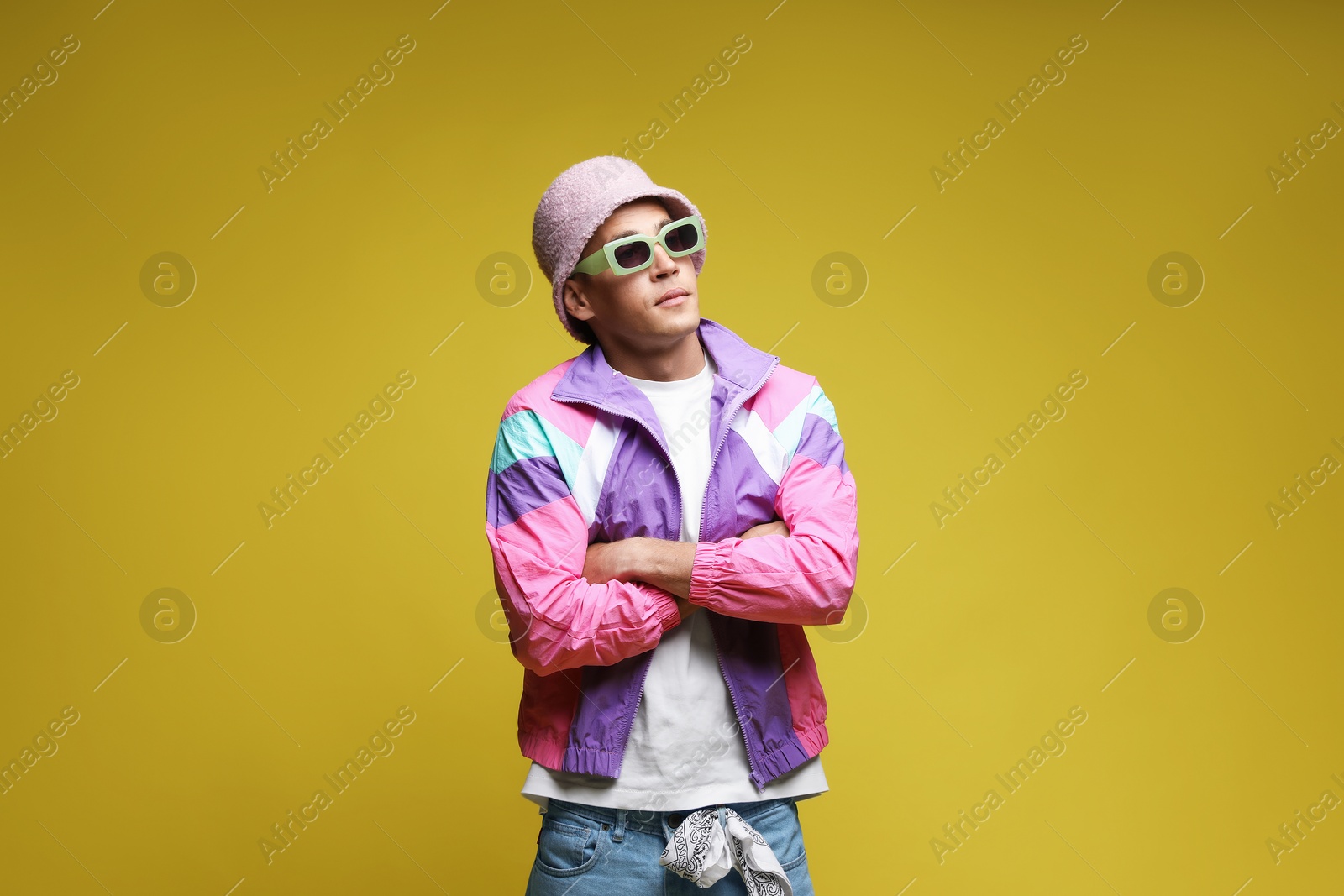 Fashionable portrait of handsome man in stylish outfit on olive background Photo of Fashionable portrait of handsome man in stylish outfit on olive background