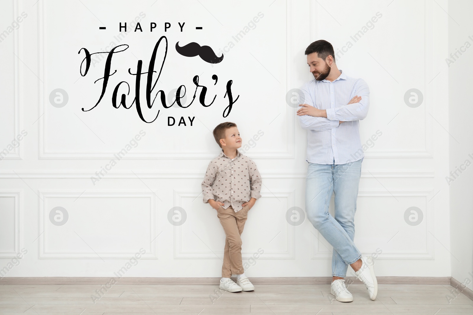 Image of Happy Father's Day. Daddy and his cute little son near white wall indoors
