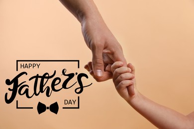 Image of Happy Father's Day. Daddy and child holding hands on beige background, closeup