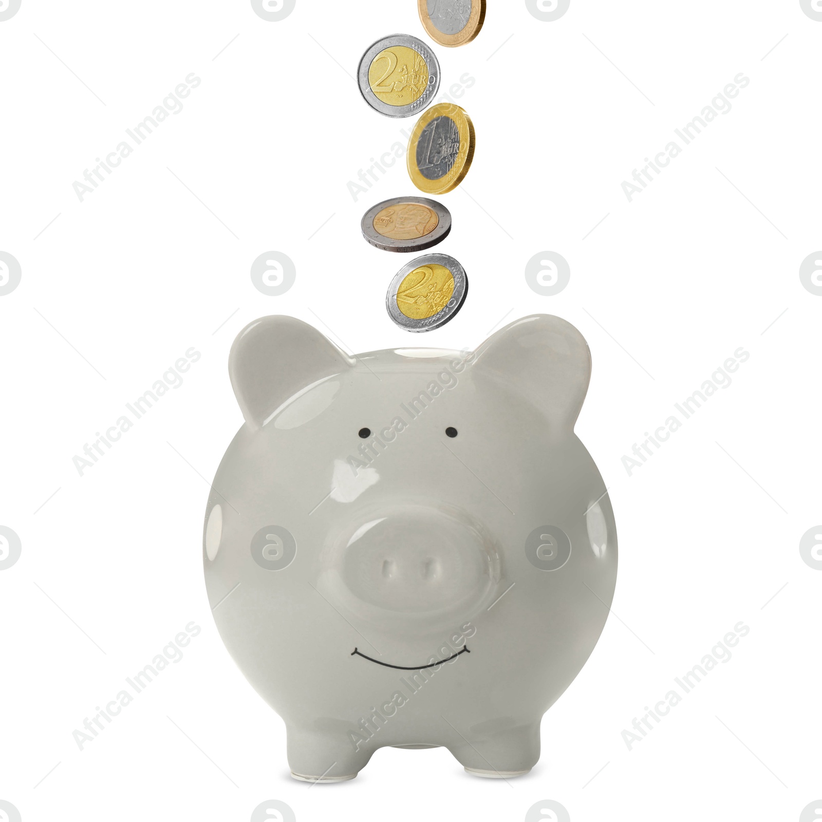 Coins falling into grey piggy bank on white background Image of Coins falling into grey piggy bank on white background