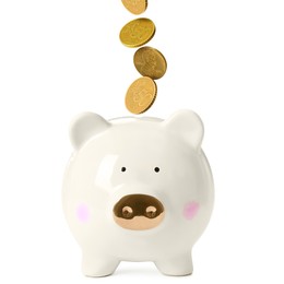 Image of Coins falling into piggy bank on white background