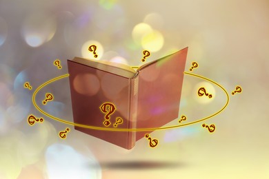 Image of Question marks and magic lights around open book in air against color background