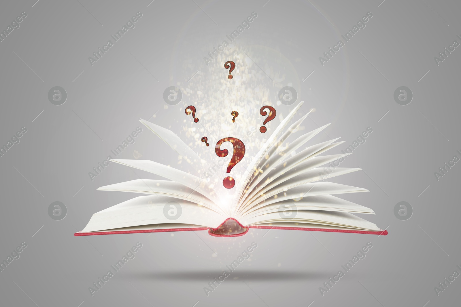 Question marks and magic lights above open book in air against grey background Image of Question marks and magic lights above open book in air against grey background