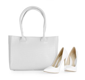 Image of White women's leather bag and high heeled shoes on white background