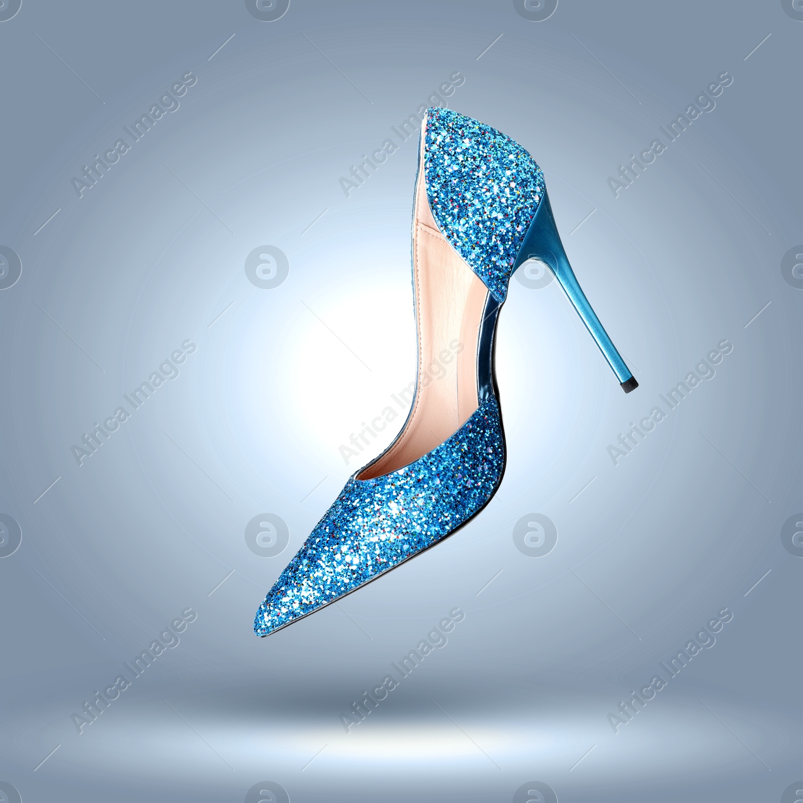 Stylish sparkly high heel shoe in air on blue grey gradient background Image of Stylish sparkly high heel shoe in air on blue grey gradient background