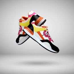 Image of Fashionable sneakers in air on grey gradient background