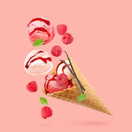 Image of Yummy ice cream cone and raspberries in air on pink background