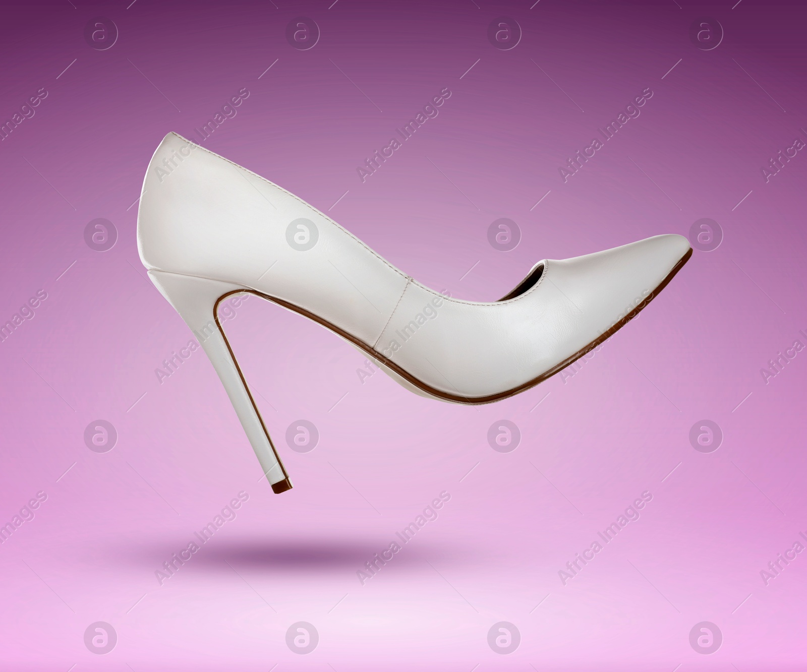 Stylish white high heeled shoe in air on purple gradient background Image of Stylish white high heeled shoe in air on purple gradient background