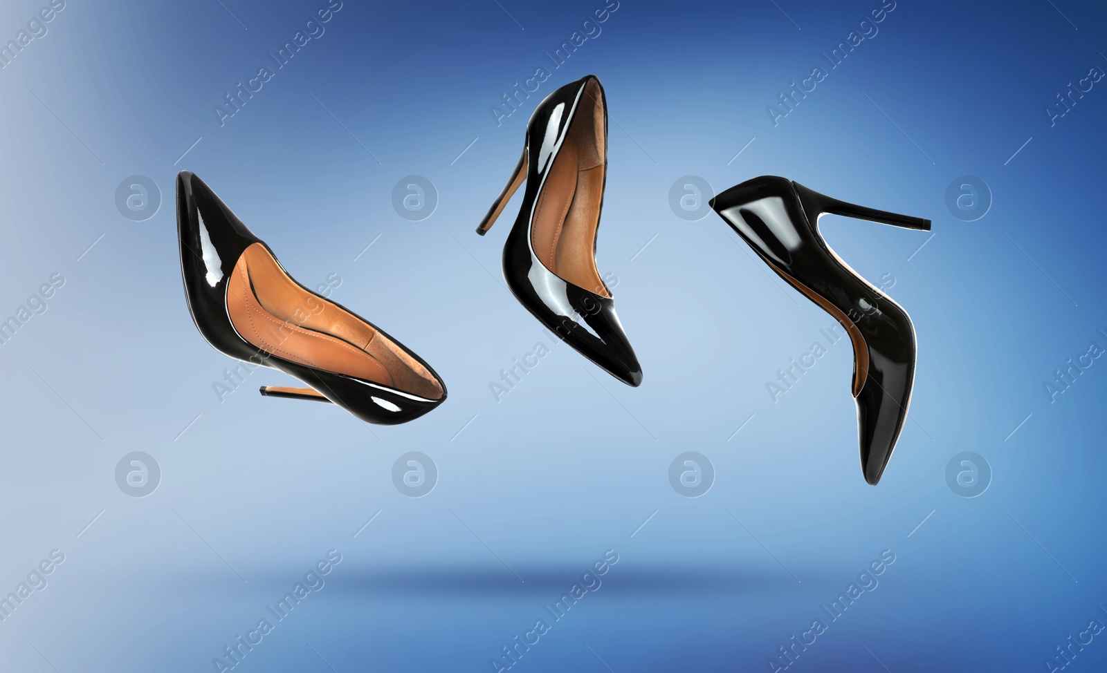Black high heeled shoes in air on blue gradient background Image of Black high heeled shoes in air on blue gradient background