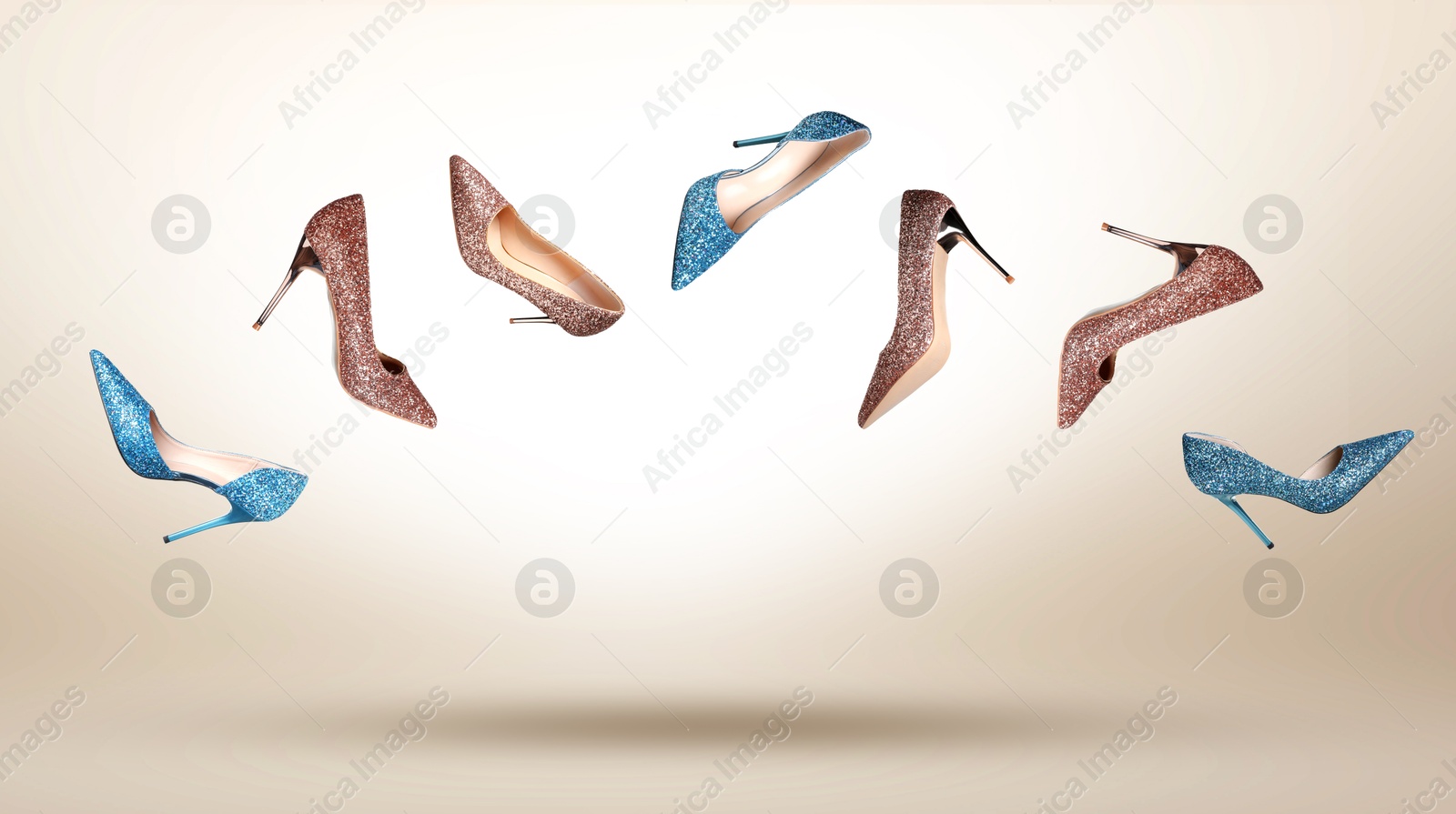 Stylish sparkly high heel shoes in air on beige gradient background Image of Stylish sparkly high heel shoes in air on beige gradient background