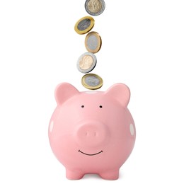 Image of Coins falling into pink piggy bank on white background