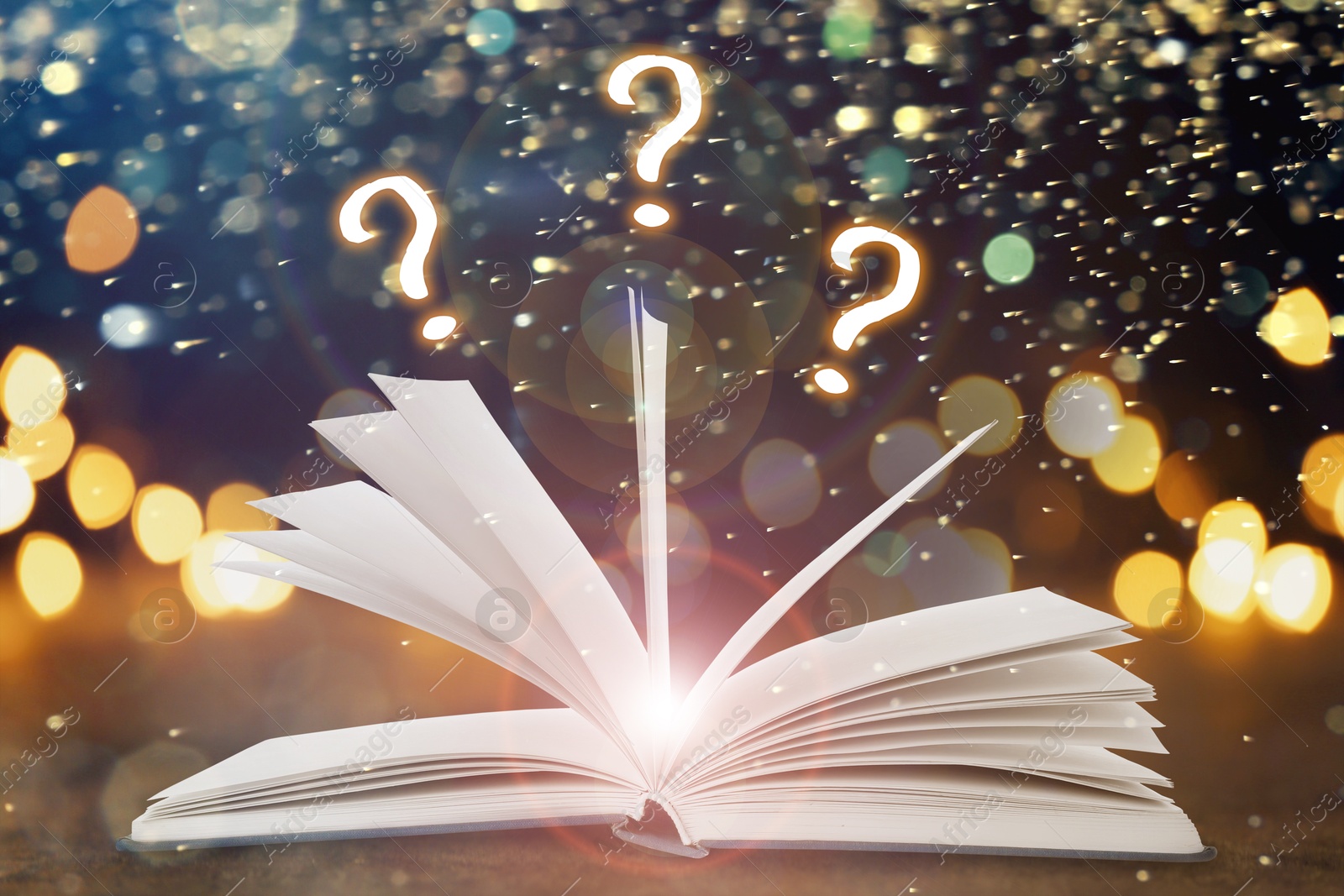 Question marks above open book on table against black background with blurred lights Image of Question marks above open book on table against black background with blurred lights