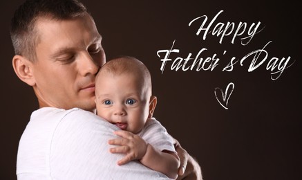 Image of Happy Father's Day. Happy daddy with his little baby on dark background