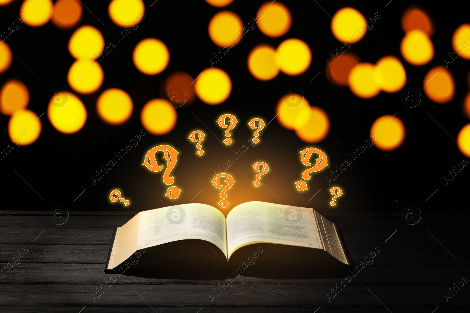 Question marks above open book on table against black background with blurred lights Image of Question marks above open book on table against black background with blurred lights
