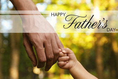 Image of Happy Father's Day. Daughter holding daddy's hand outdoors, closeup