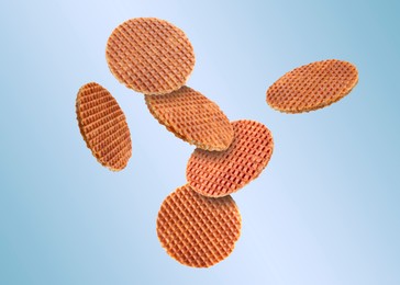 Image of Yummy Dutch waffles (stroopwafels) flying on light blue gradient background
