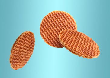 Image of Yummy Dutch waffles (stroopwafels) flying on light blue gradient background