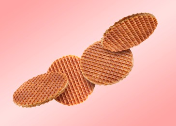 Image of Yummy Dutch waffles (stroopwafels) flying on pink gradient background