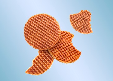 Image of Yummy Dutch waffles (stroopwafels) flying on light blue gradient background