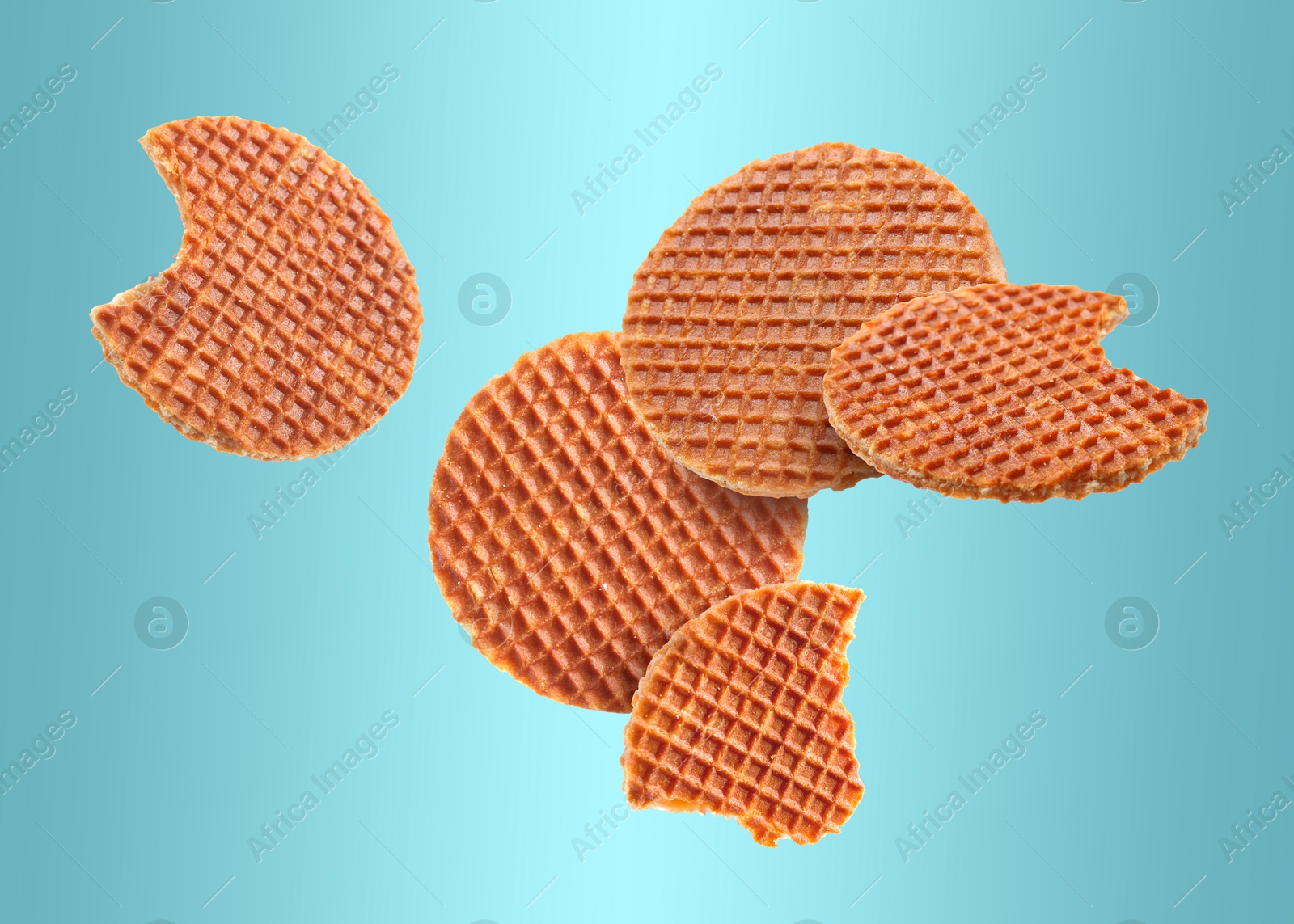 Image of Yummy Dutch waffles (stroopwafels) flying on light blue gradient background