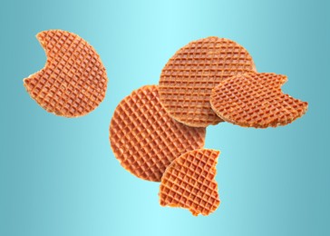 Image of Yummy Dutch waffles (stroopwafels) flying on light blue gradient background