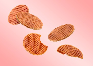 Image of Yummy Dutch waffles (stroopwafels) flying on pink gradient background