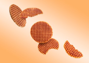 Image of Yummy Dutch waffles (stroopwafels) flying on orange gradient background