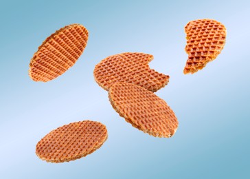 Image of Yummy Dutch waffles (stroopwafels) flying on light blue gradient background