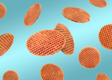 Image of Yummy Dutch waffles (stroopwafels) flying on light blue gradient background