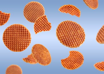 Image of Yummy Dutch waffles (stroopwafels) flying on light blue gradient background