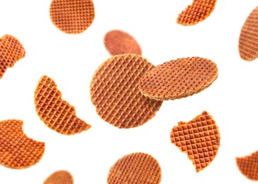 Image of Yummy Dutch waffles (stroopwafels) flying on white background