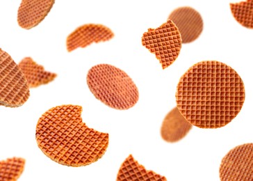 Image of Yummy Dutch waffles (stroopwafels) flying on white background