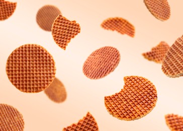 Image of Yummy Dutch waffles (stroopwafels) flying on beige gradient background