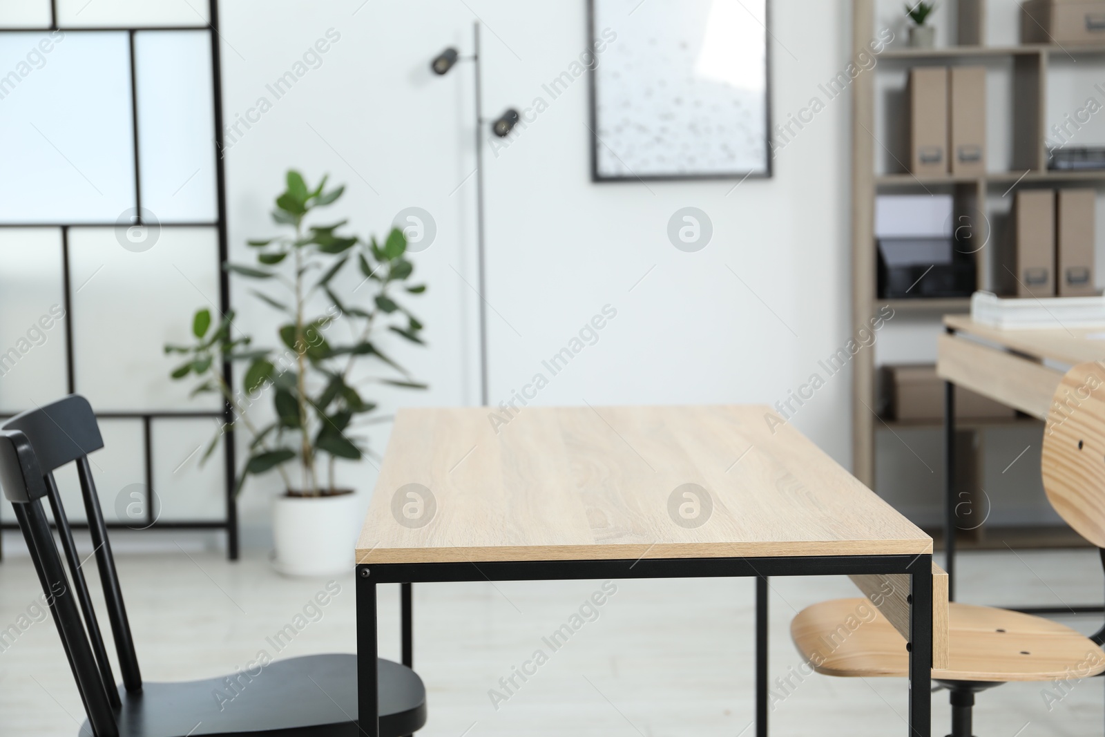 Wooden desk and chairs indoors, closeup. Office interior Photo of Wooden desk and chairs indoors, closeup. Office interior