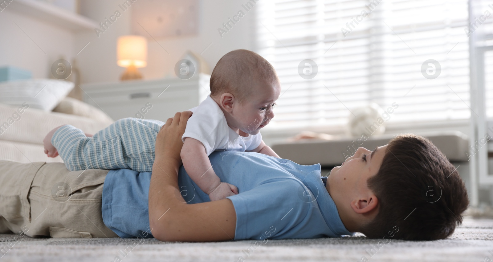 Cute little brothers on floor at home Photo of Cute little brothers on floor at home