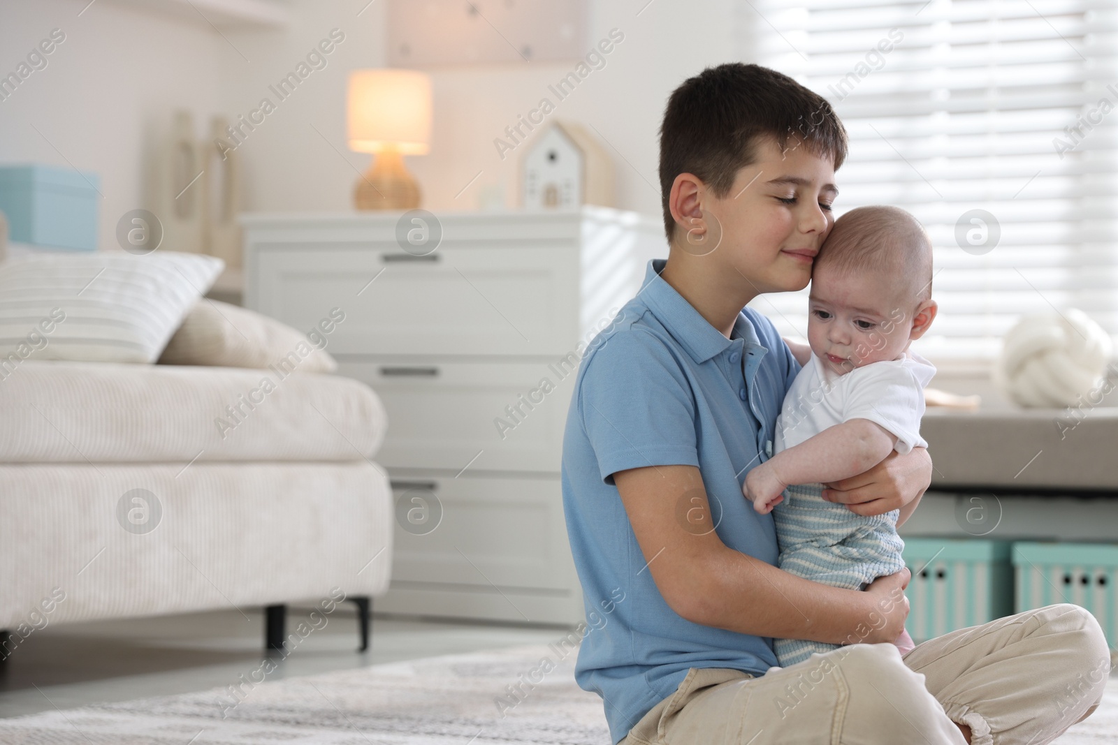 Cute little brothers hugging on floor at home. Space for text Photo of Cute little brothers hugging on floor at home. Space for text