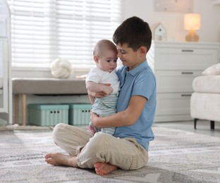 Photo of Cute little brothers hugging on floor at home