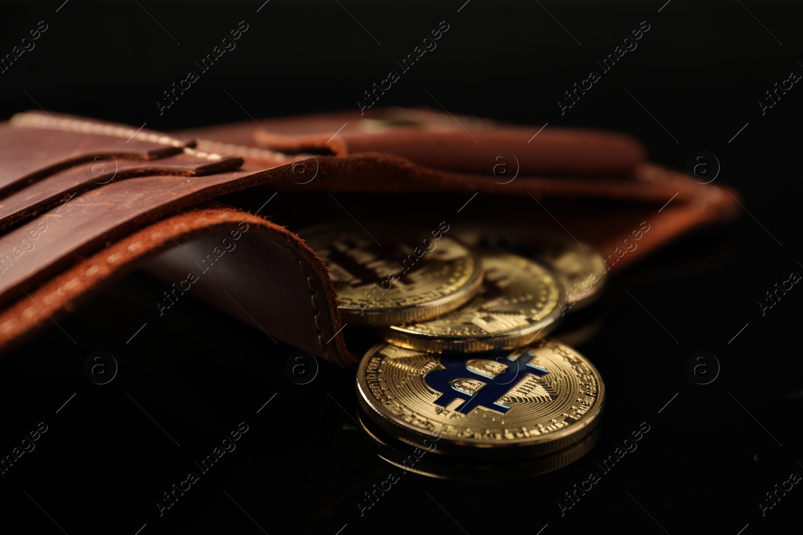 Cryptocurrency. Bitcoins in wallet on black mirror surface, closeup Photo of Cryptocurrency. Bitcoins in wallet on black mirror surface, closeup