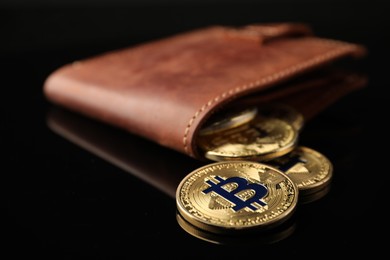 Photo of Cryptocurrency. Bitcoins in wallet on black mirror surface, closeup