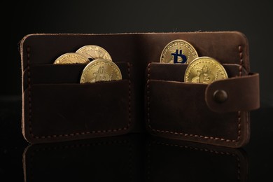 Photo of Cryptocurrency. Bitcoins in wallet on black mirror surface, closeup