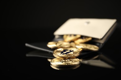 Photo of Cryptocurrency. Bitcoins in wallet on black mirror surface, closeup. Space for text