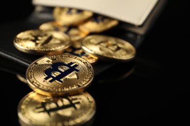 Photo of Cryptocurrency. Bitcoins in wallet on black mirror surface, closeup. Space for text
