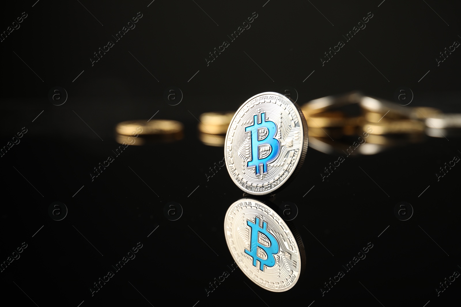 Cryptocurrency. Bitcoins on black mirror surface, closeup. Space for text Photo of Cryptocurrency. Bitcoins on black mirror surface, closeup. Space for text